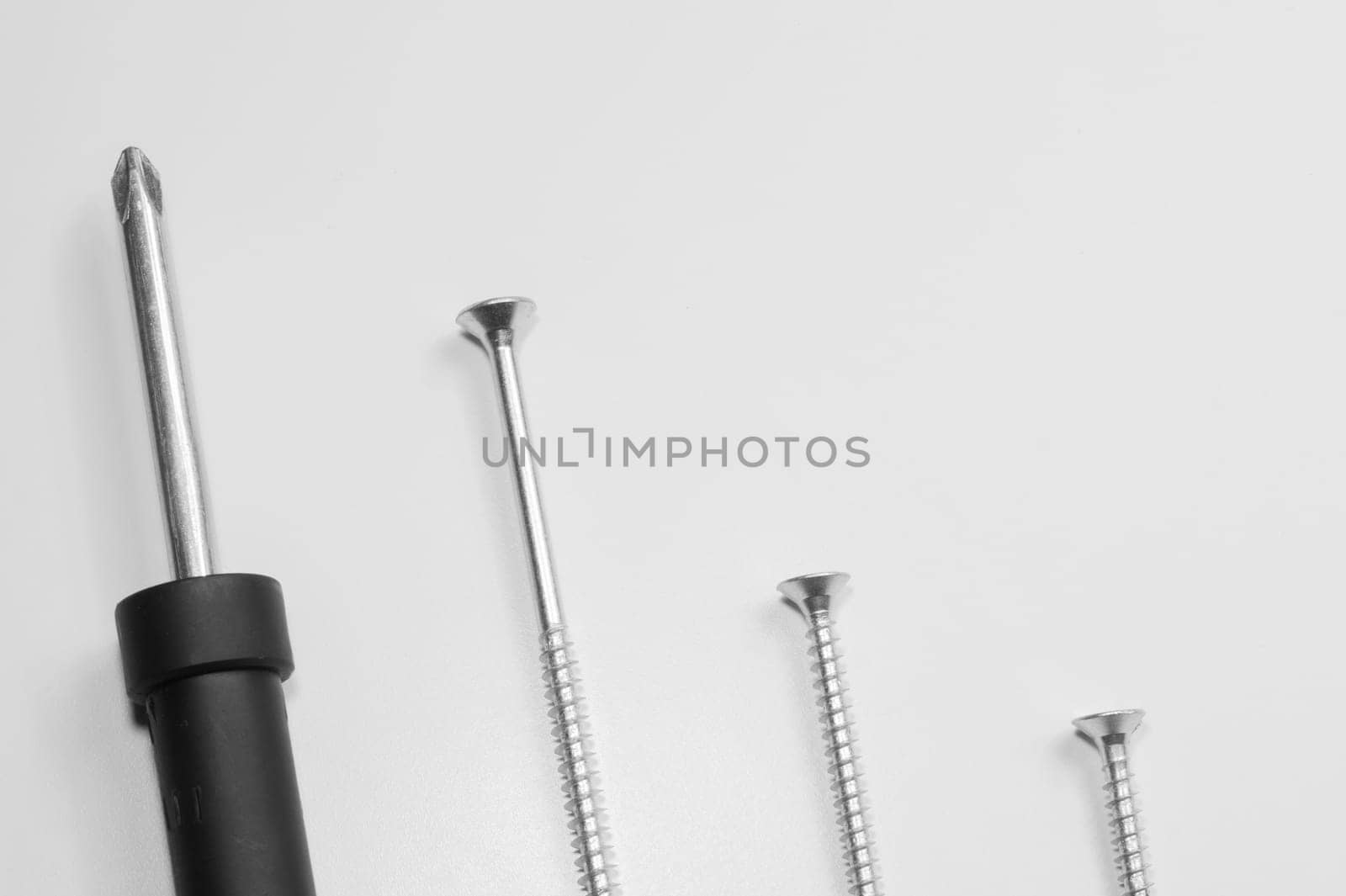 Steel screw on a white background. working tools