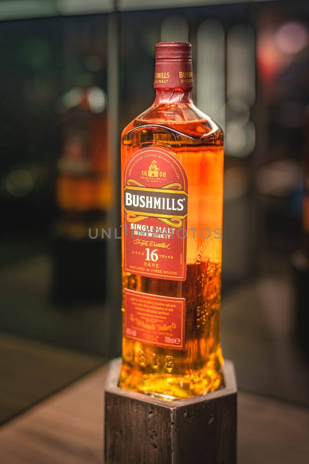 Bushmills, Northern Ireland, Aug 2019 Selective focus on rare, aged 16 year Bushmills whiskey on illuminated display in distillery shop