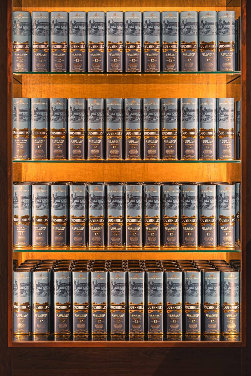 Bushmills, Northern Ireland, Aug 2019 Rows of aged 12 years Bushmills whiskey in a boxes, on illuminated display in distillery shop
