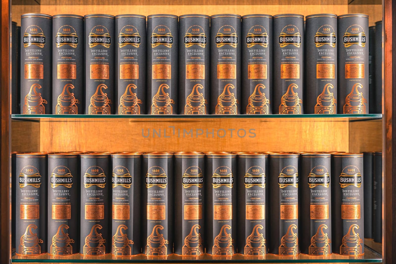 Bushmills, Northern Ireland, Aug 2019 Rows of distillery exclusive, Bushmills whiskey matured in acacia wood barrels, on illuminated display