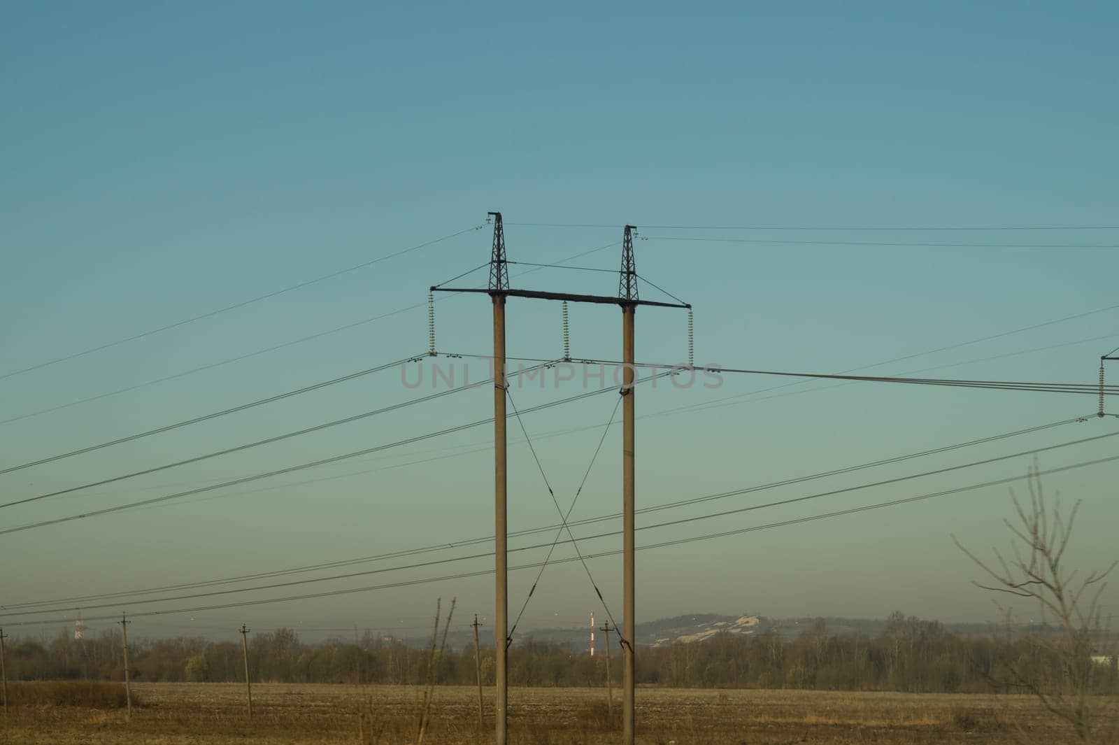 Power line posts. high voltage tower with the sky. industrial background
