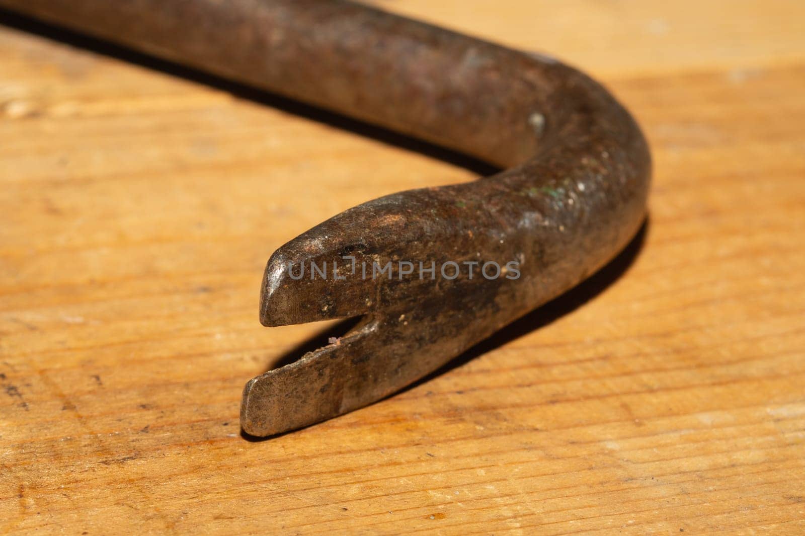 Nail puller on a wooden table. working tool. carpentry instrument