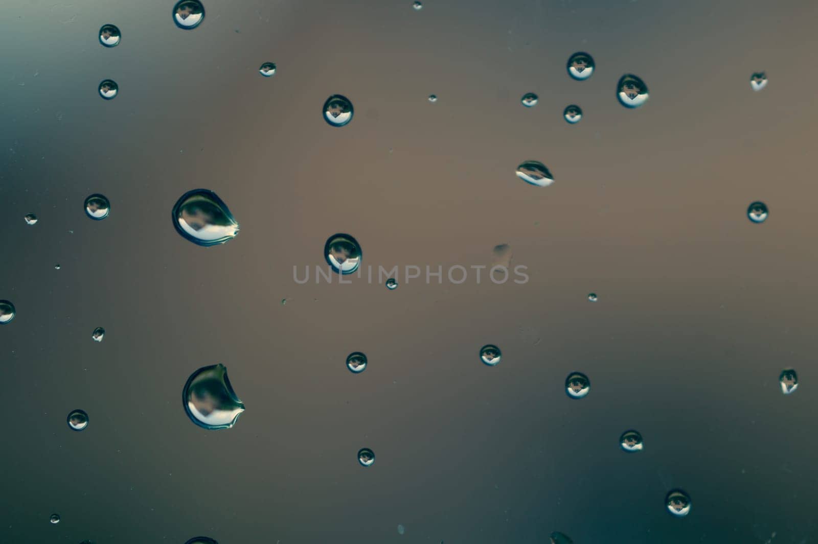 Raindrops on window glass close up. water drops macro background