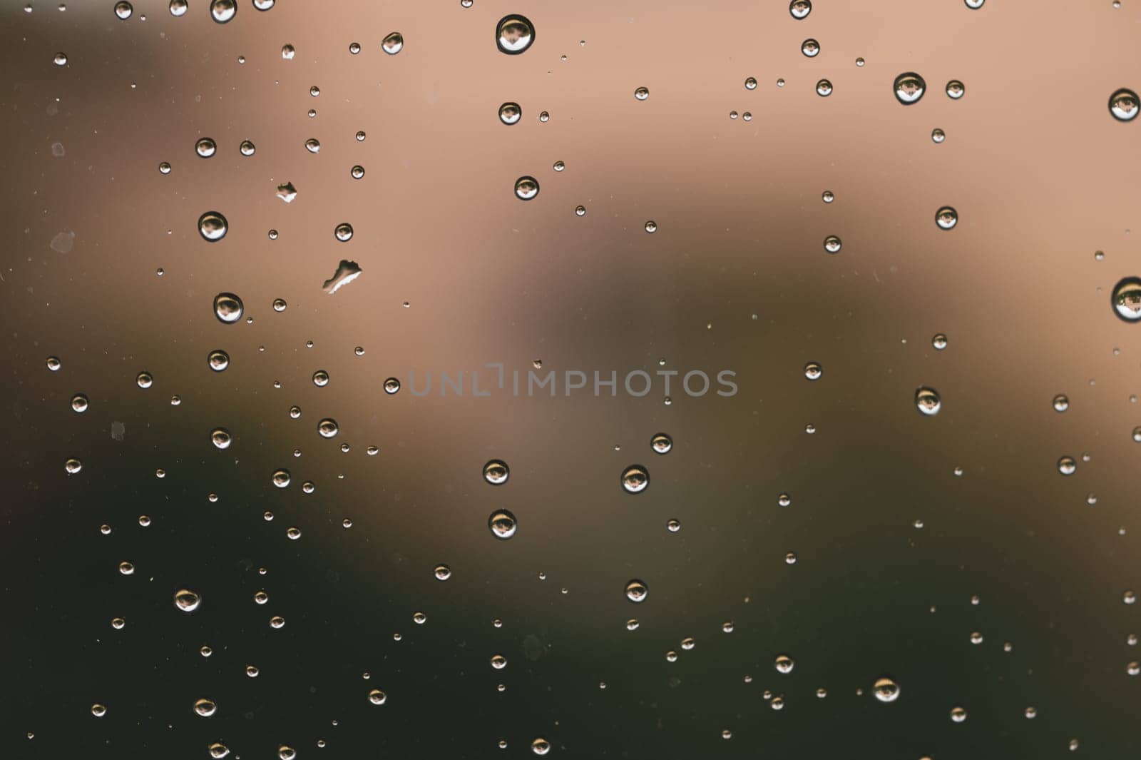 Raindrops on window glass close up. water drops macro background