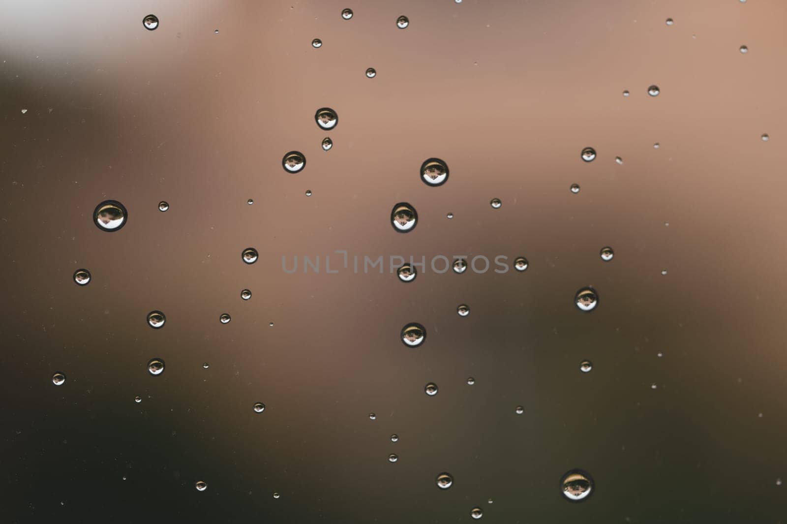 Raindrops on window glass close up. water drops macro background
