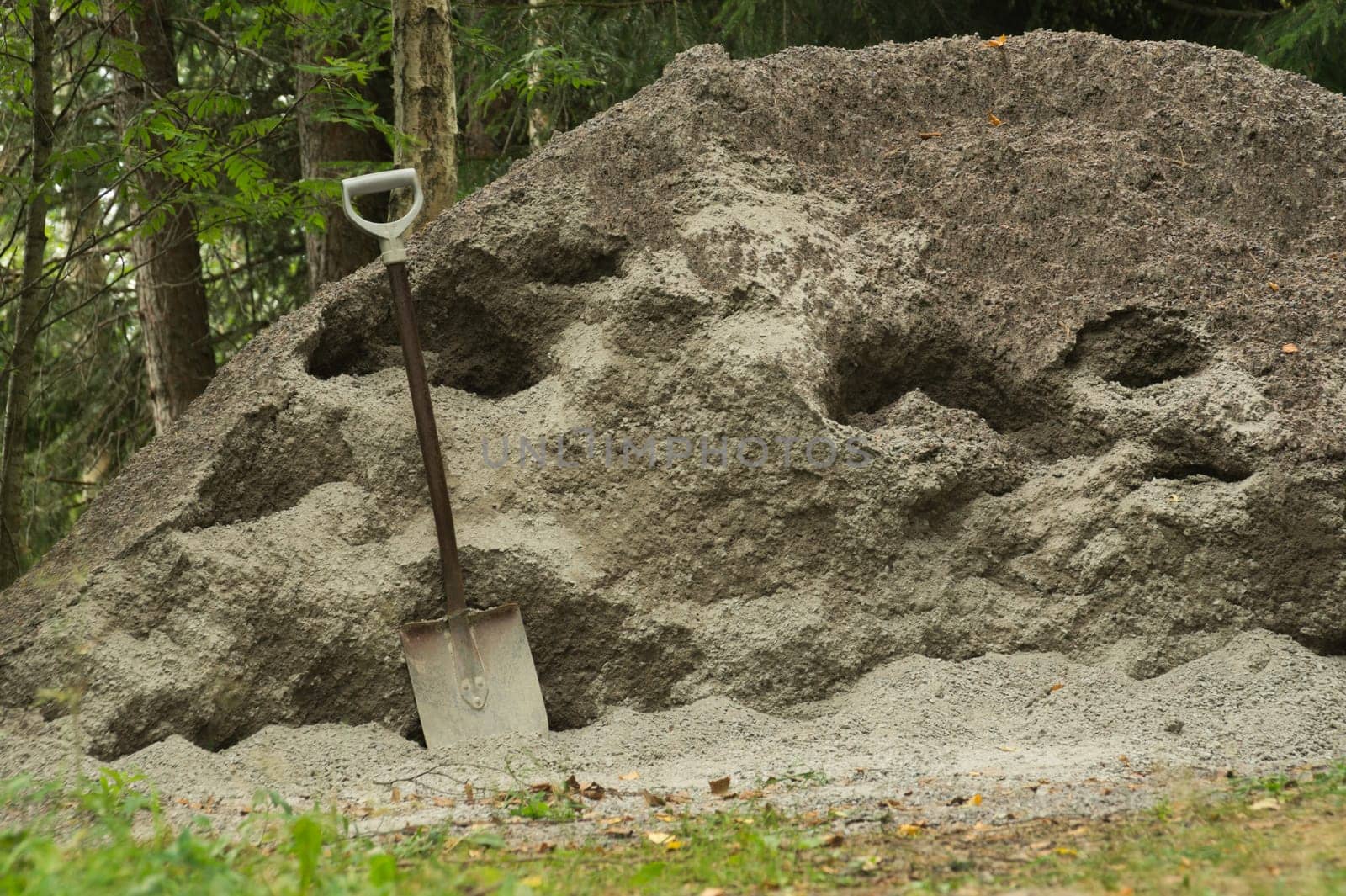 Shovel placed on a sand hill. manual labor background