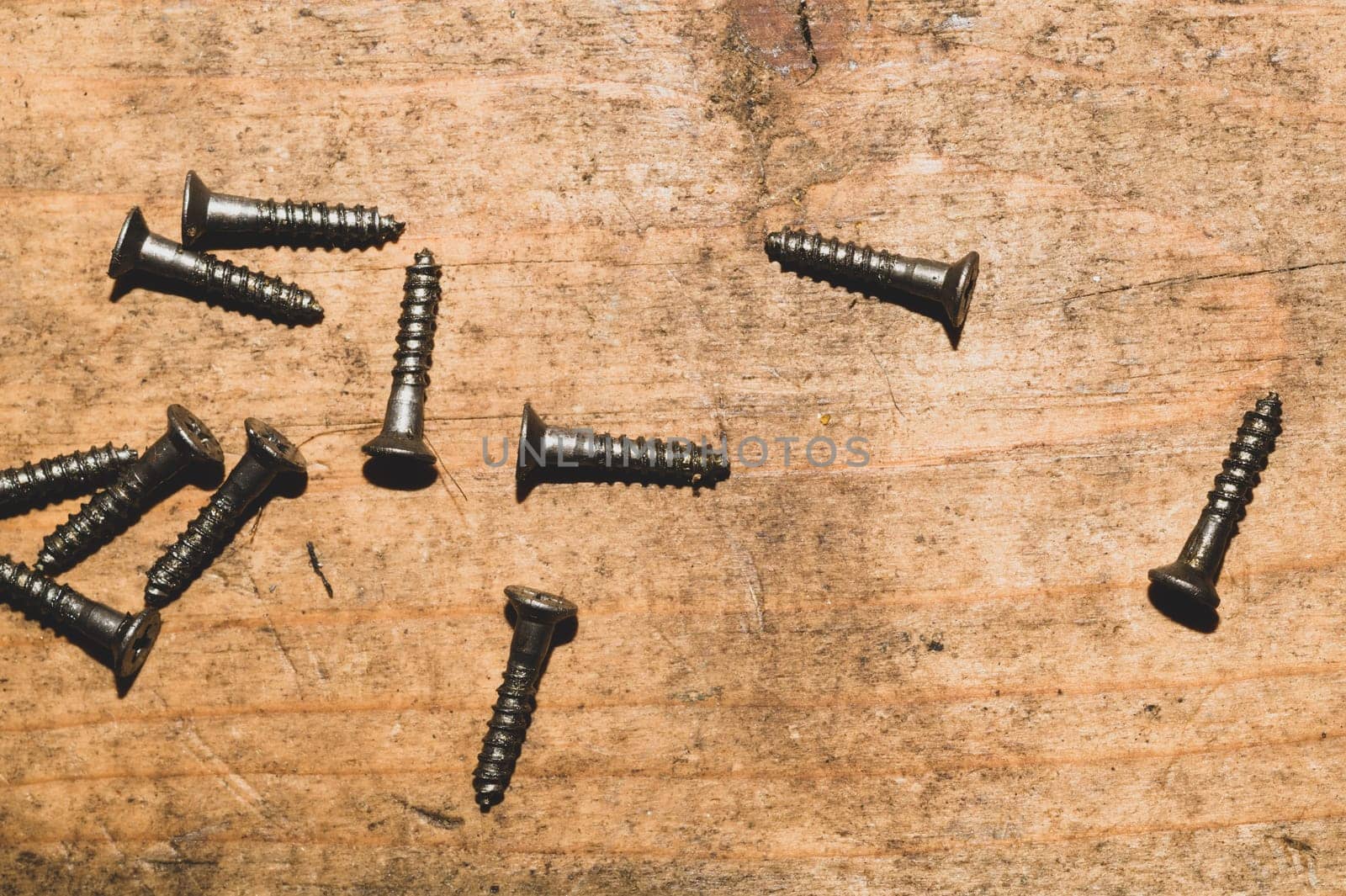 Screws on a wooden background.working tools. copy space