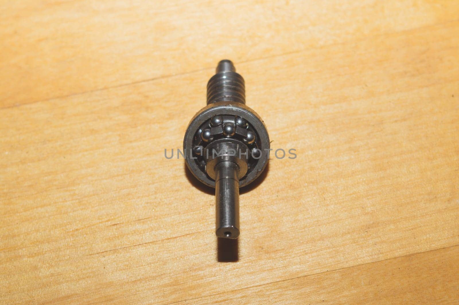 Metal shaft and bearing on a wooden table
