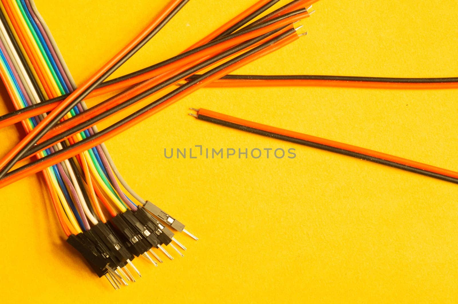 Colorful wires isolated on yellow background. connection wire for electrical schemes and devices. copy space