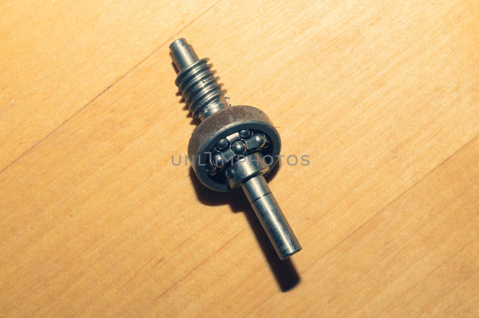 Metal shaft and bearing on a wooden table