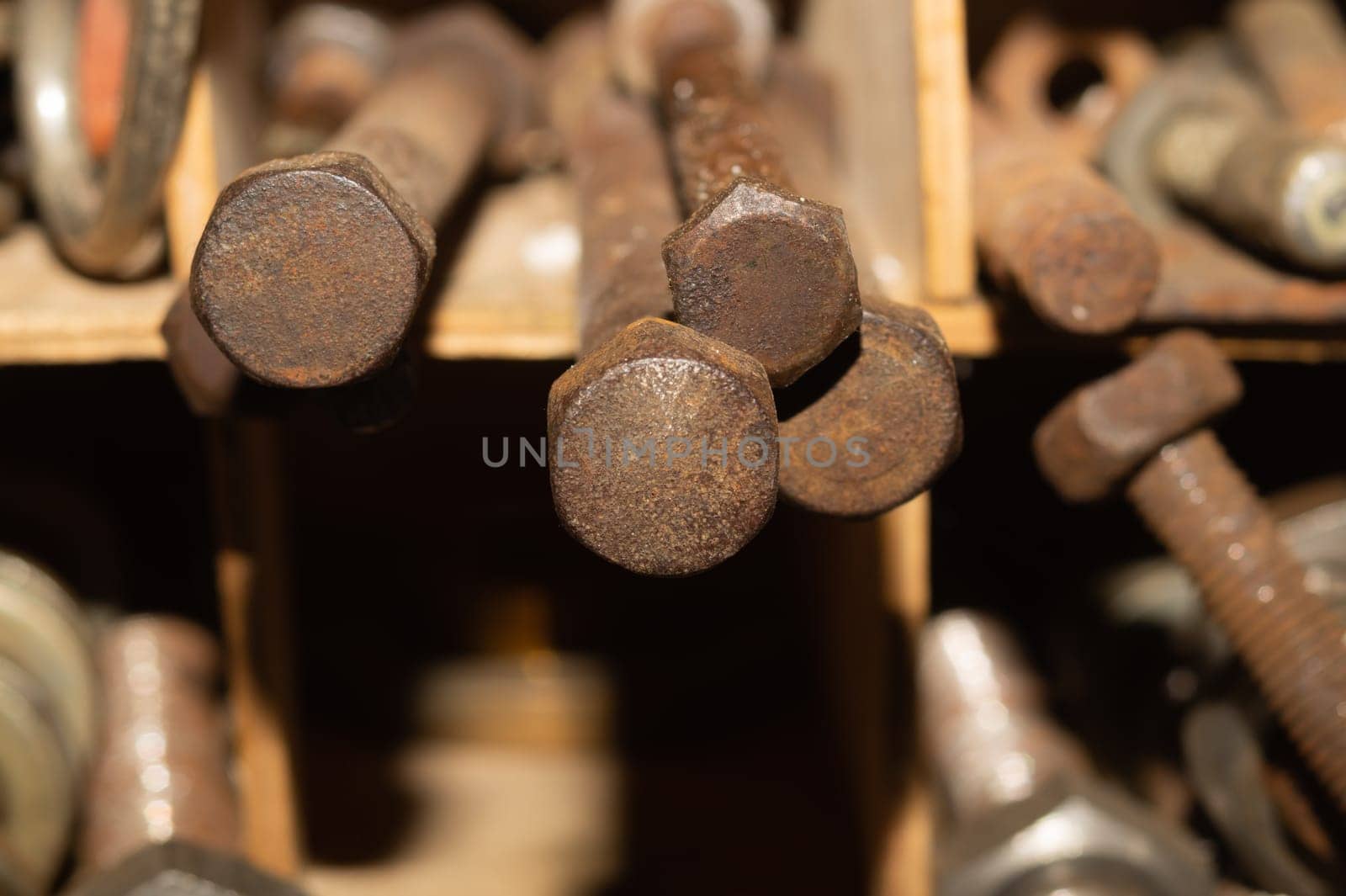 Old screws in a box. a lot of various screws. pile of fasteners in the box close up. carpentry workshop. work tool