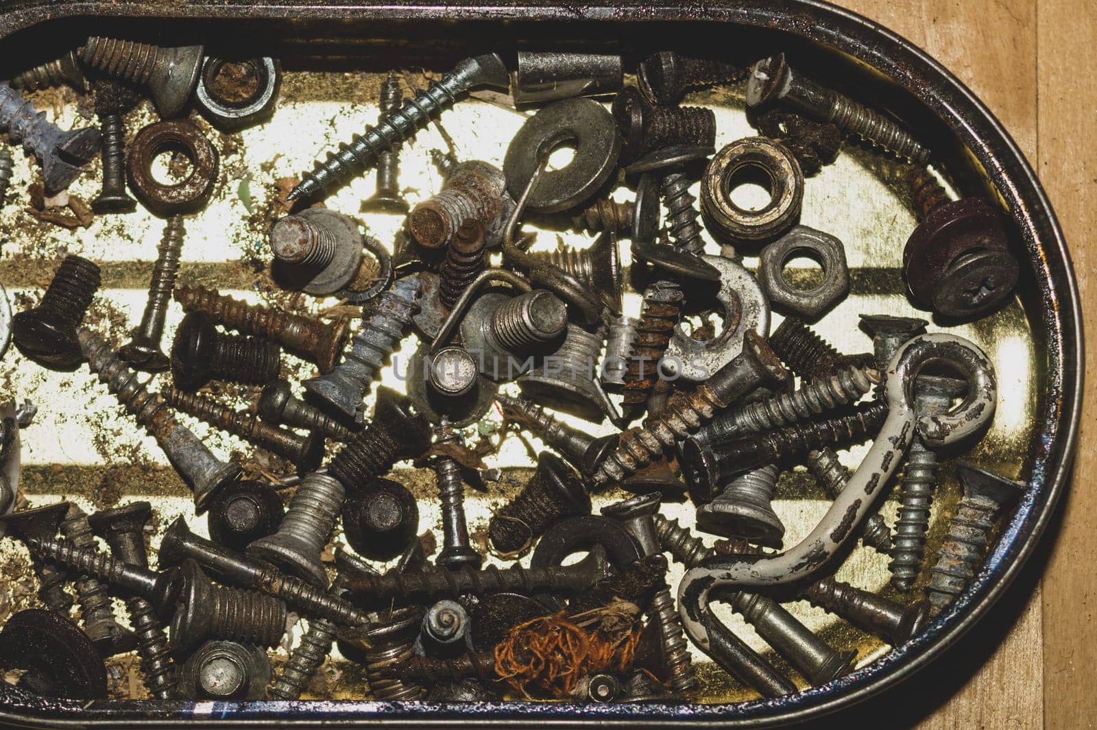 Old screws in a box. a lot of various screws. pile of fasteners in the box close up. carpentry workshop. work tool