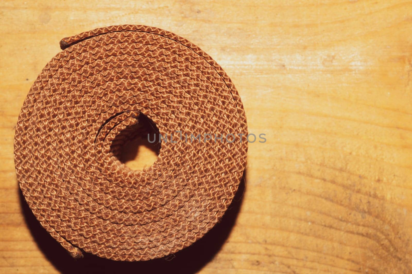 Industrial harness rolled up on a wooden table. work tool