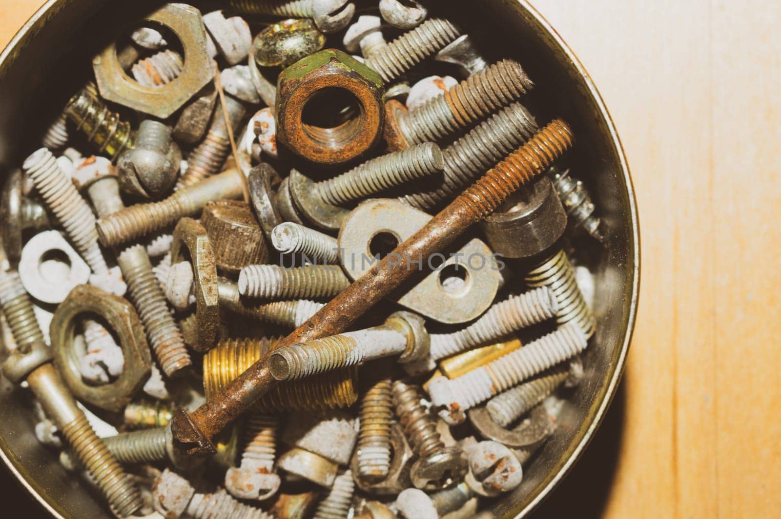 Old screws in a box. a lot of various screws. pile of fasteners in the box close up. carpentry workshop. work tool