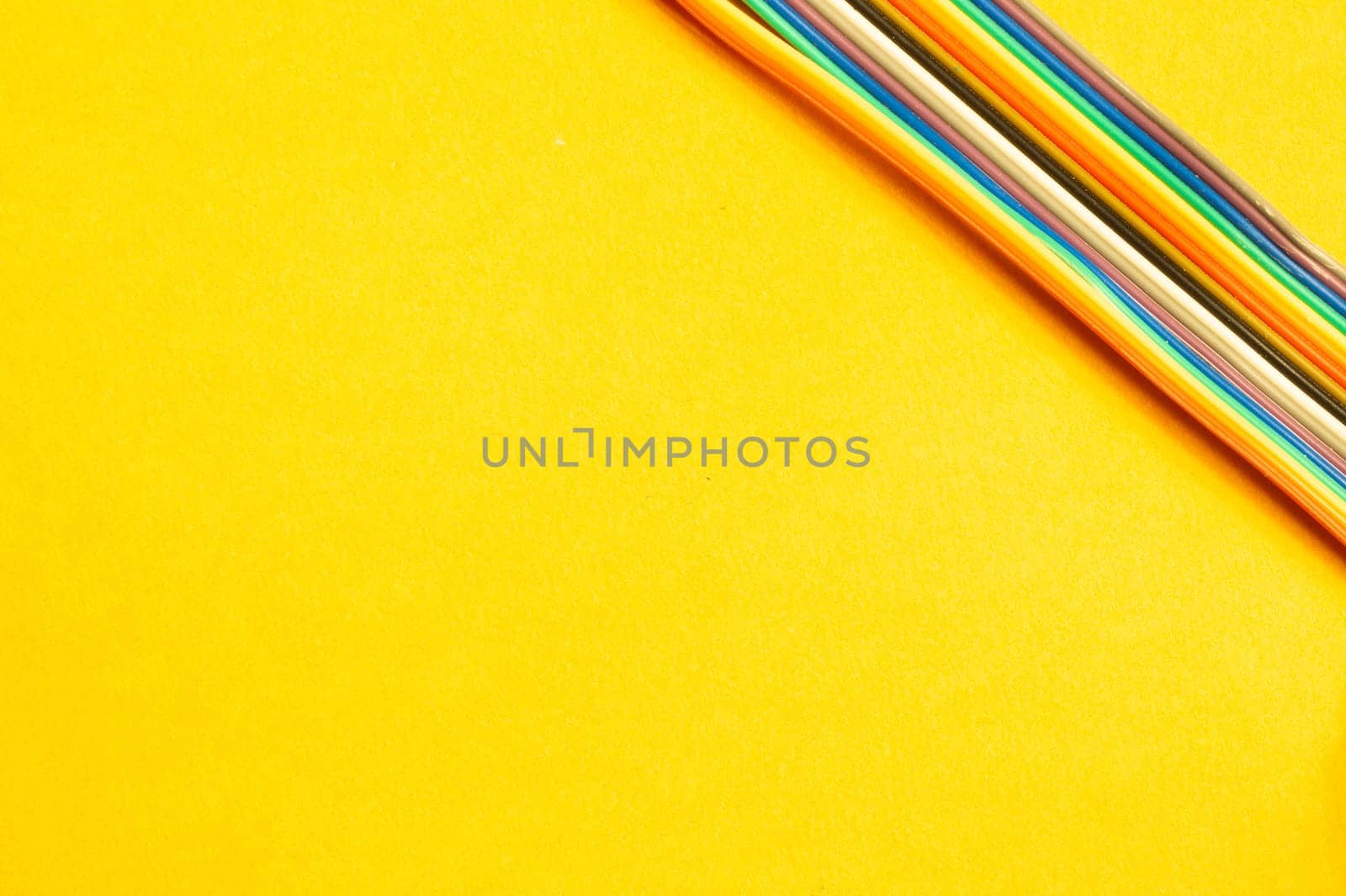 Colorful wires isolated on yellow background. connection wire for electrical schemes and devices. copy space