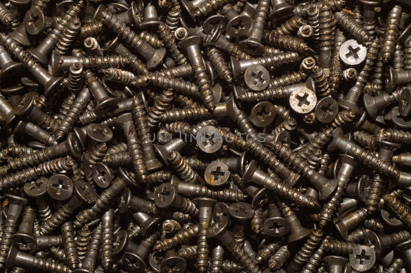 Screws background. heap of tapping screws. work tool. pile of fasteners