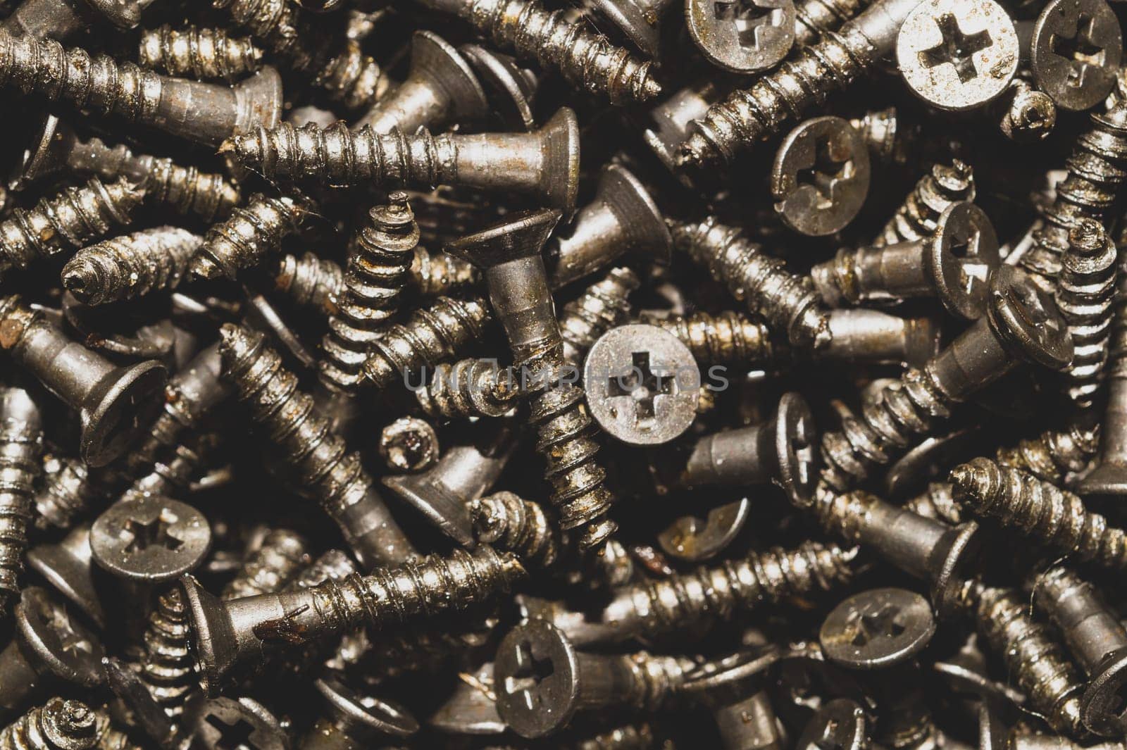 Screws background. heap of tapping screws. work tool. pile of fasteners