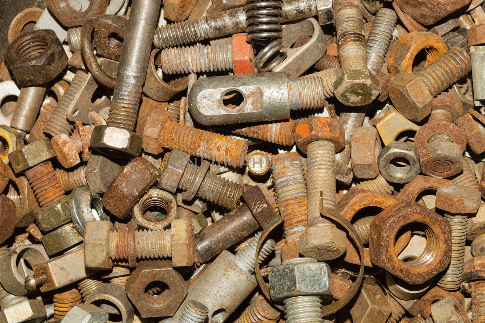 Rusty bolts and nuts of different sizes. scrap metal. industrial background