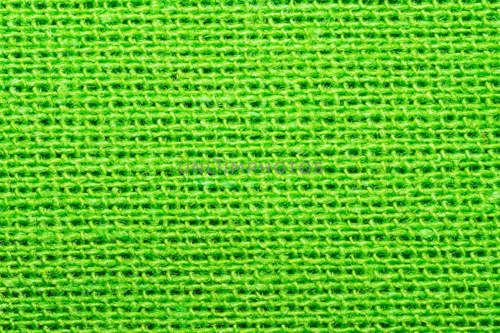 Green textile close up. knitted fabric texture. woven material background