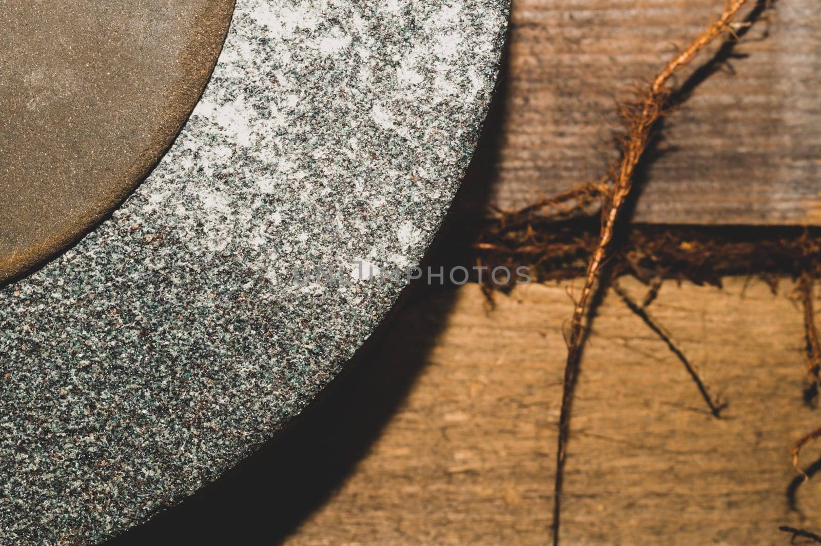 Old rusty grindstone in workshop. whetstone close up