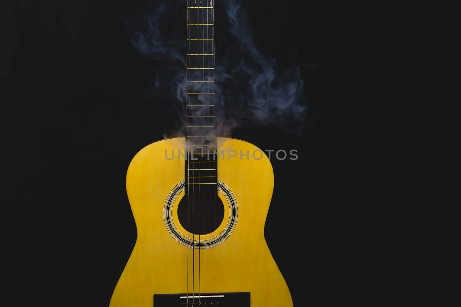 Guitar in smoke close up. musical instrument. strings on the guitar neck