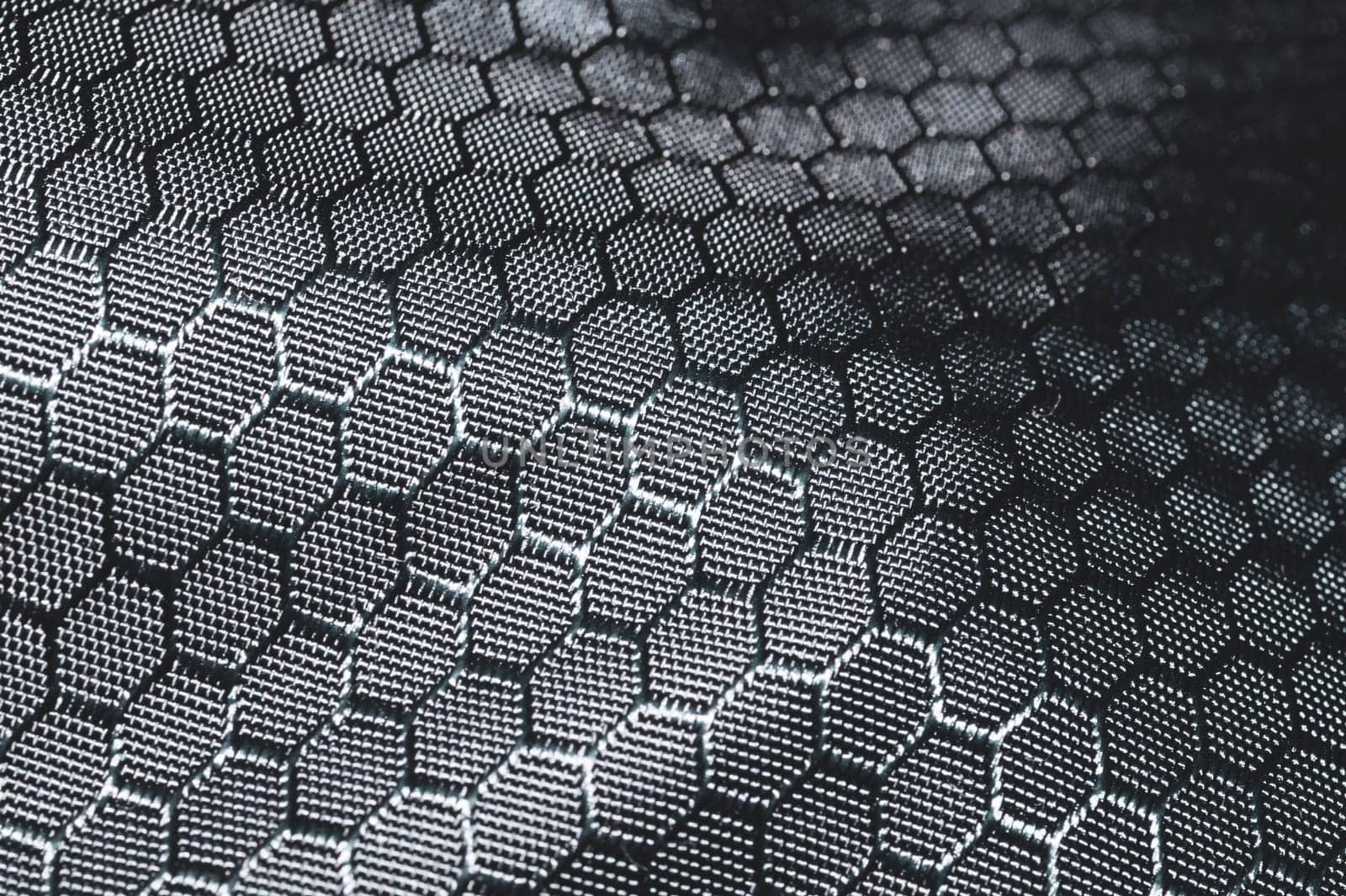 Fabric background with hex shaped cells. textile material