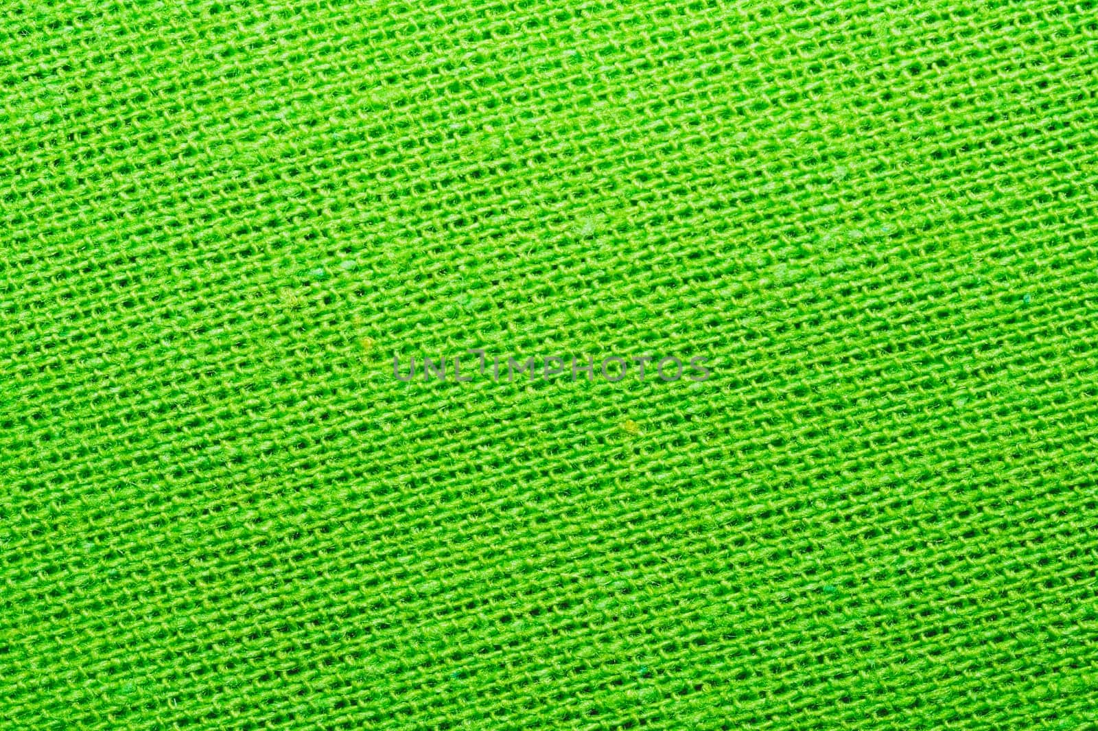 Green textile close up. knitted fabric texture. woven material background