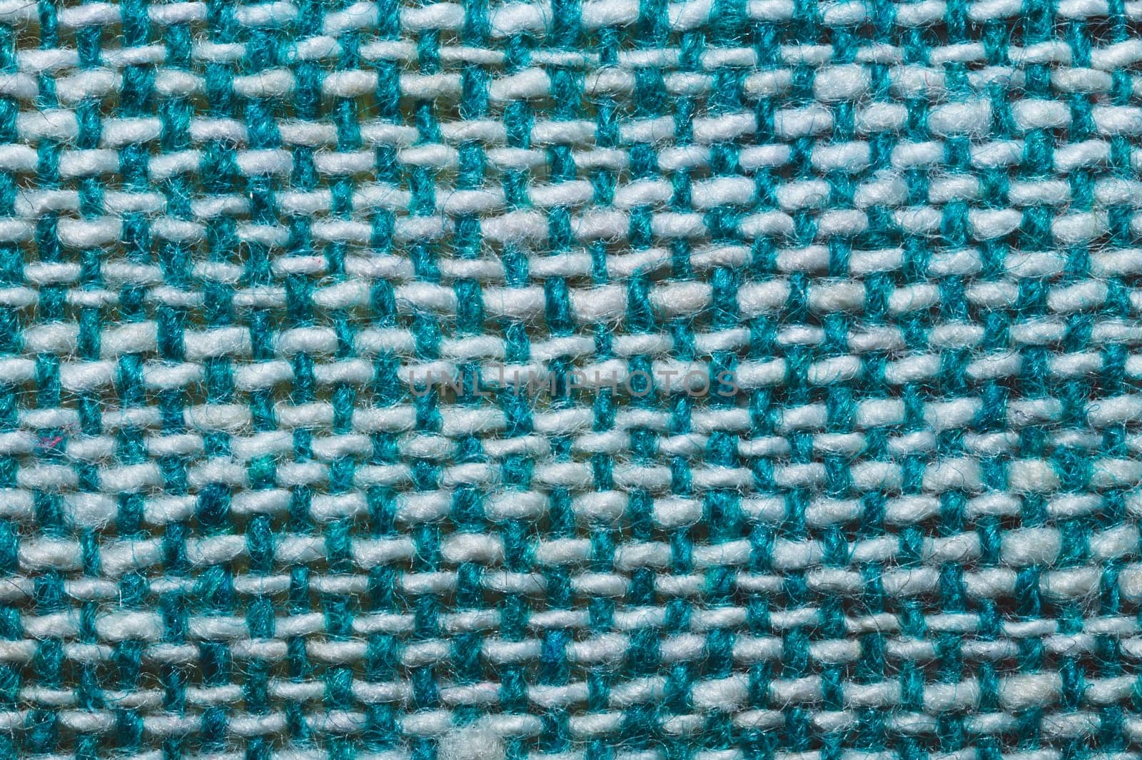 Fabric macro texture. knitted textile close up. woven background. woolen material. weaving blue and white threads