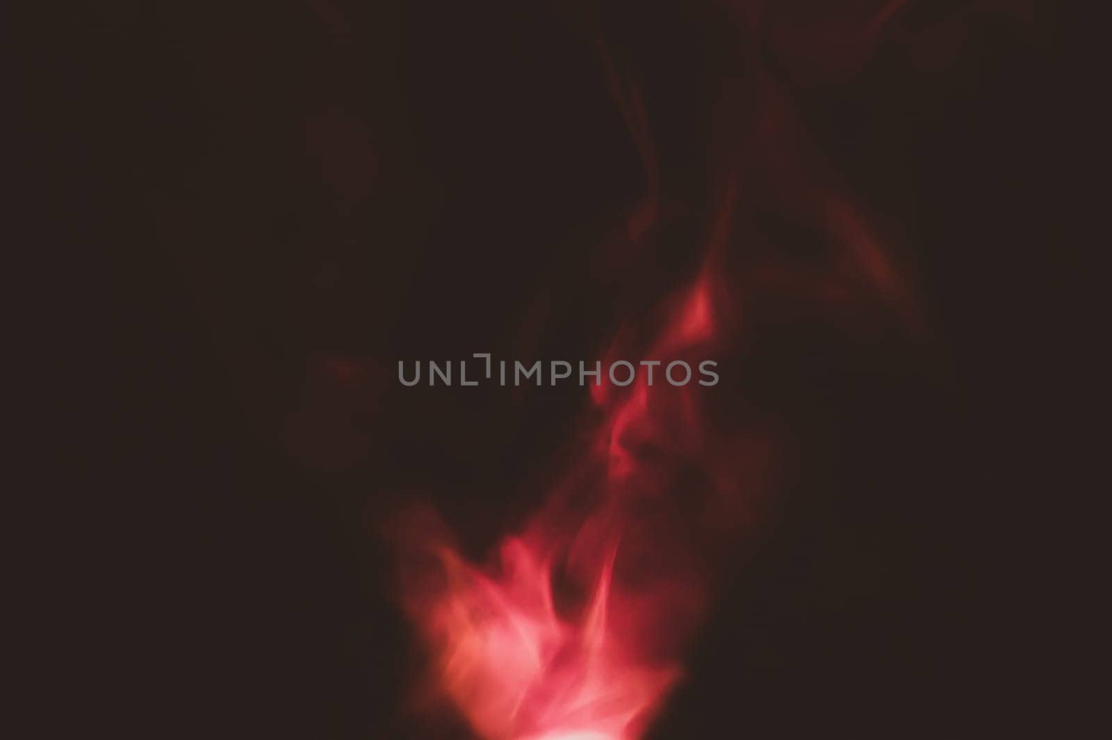 Red smoke on black backdrop. color fog abstract background