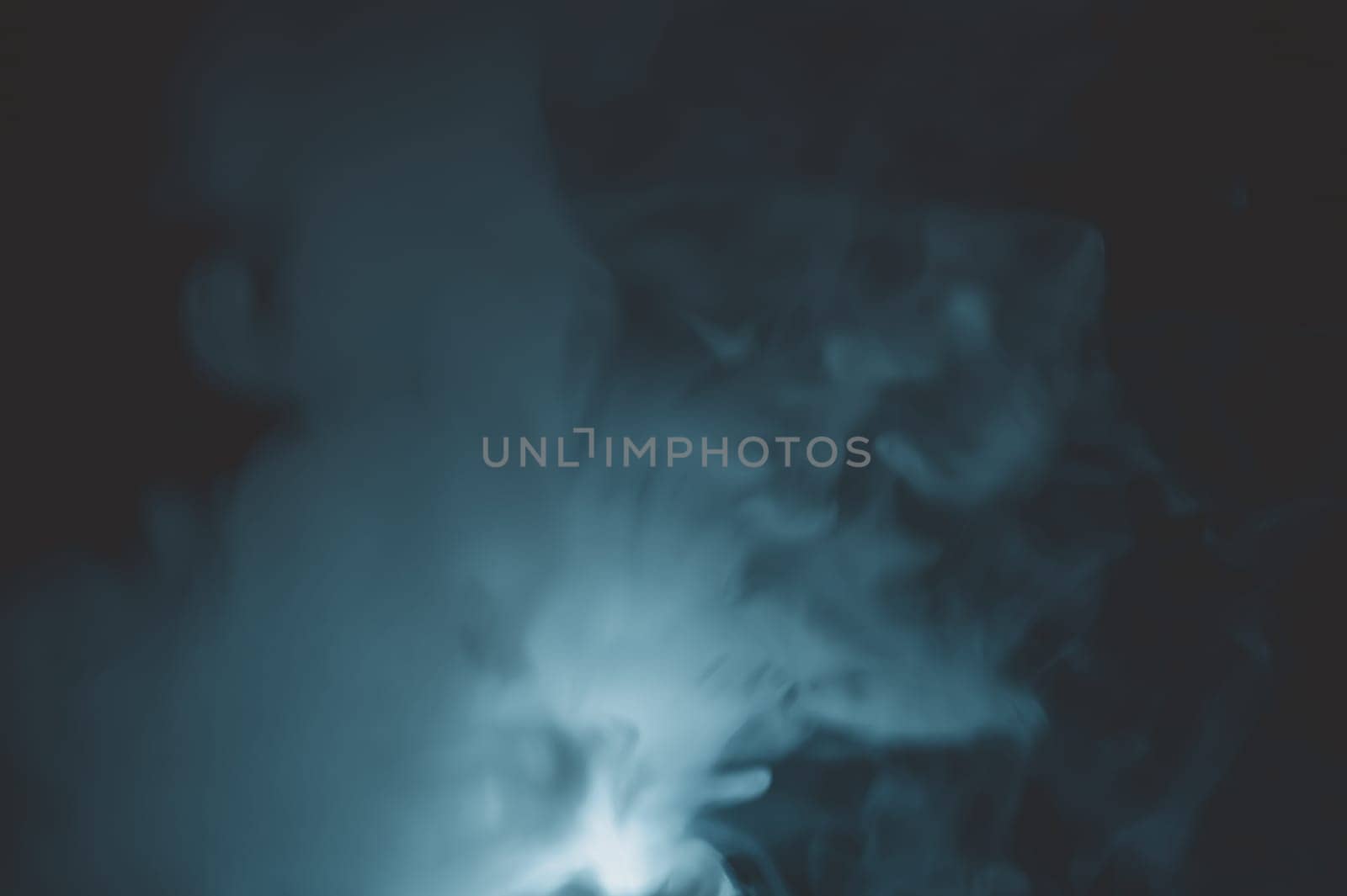 Turquoise smoke on black backdrop. color fog abstract background