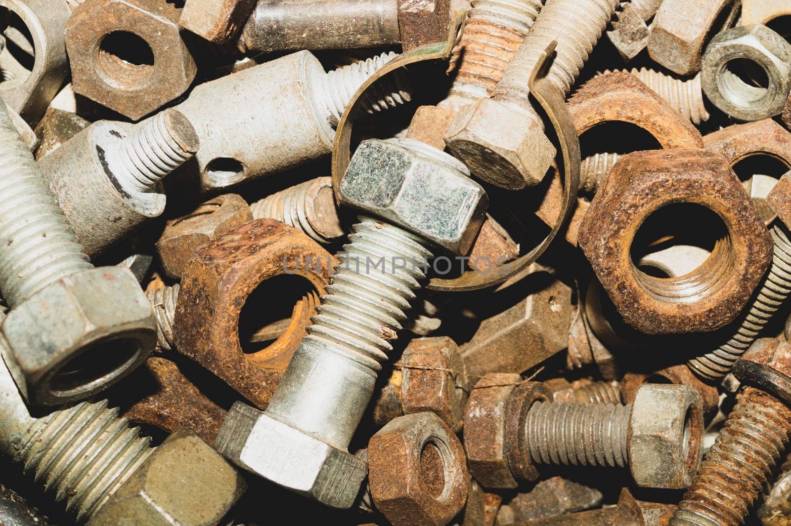 Rusty bolts and nuts of different sizes. scrap metal. industrial background