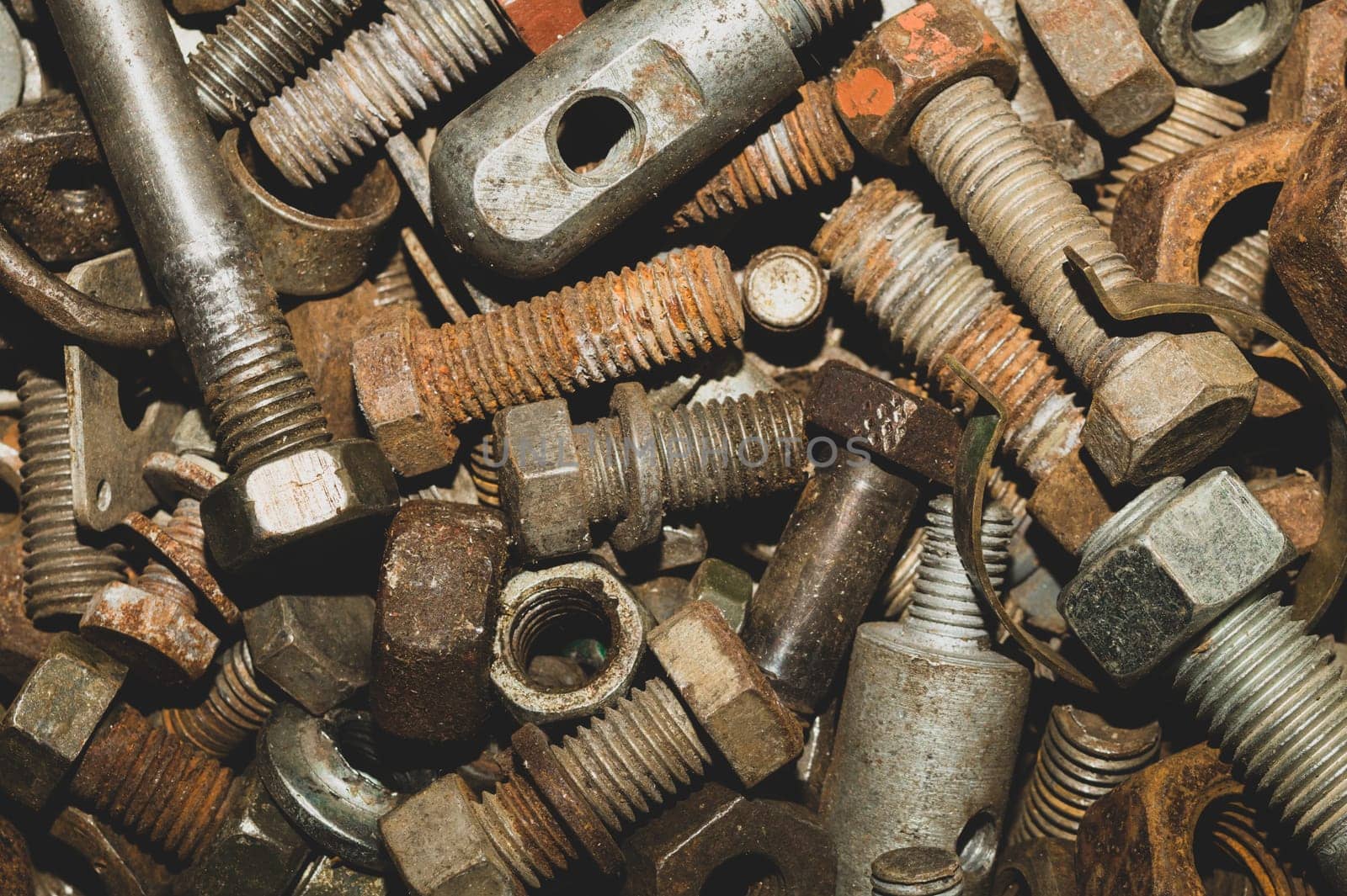 Rusty bolts and nuts of different sizes. scrap metal. industrial background