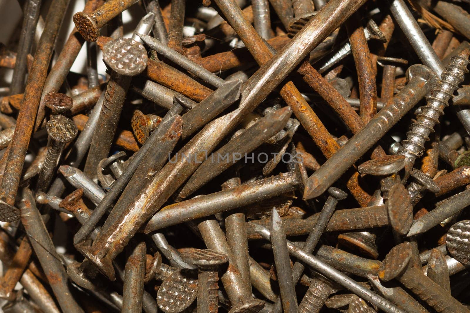 Pile of fasteners and screws close up. scrap metal. different metal parts. industrial background