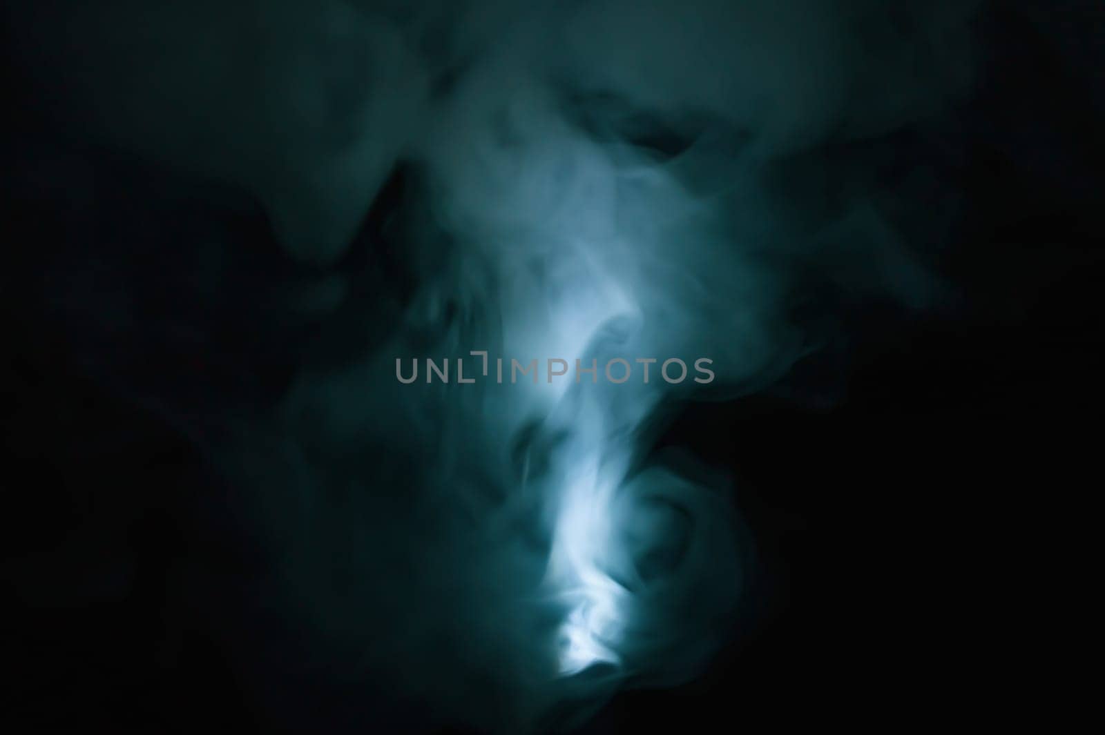 Turquoise smoke on black backdrop. color fog abstract background