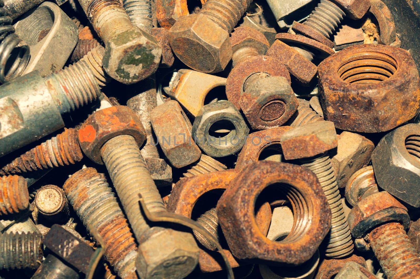 Rusty bolts and nuts of different sizes. scrap metal. industrial background