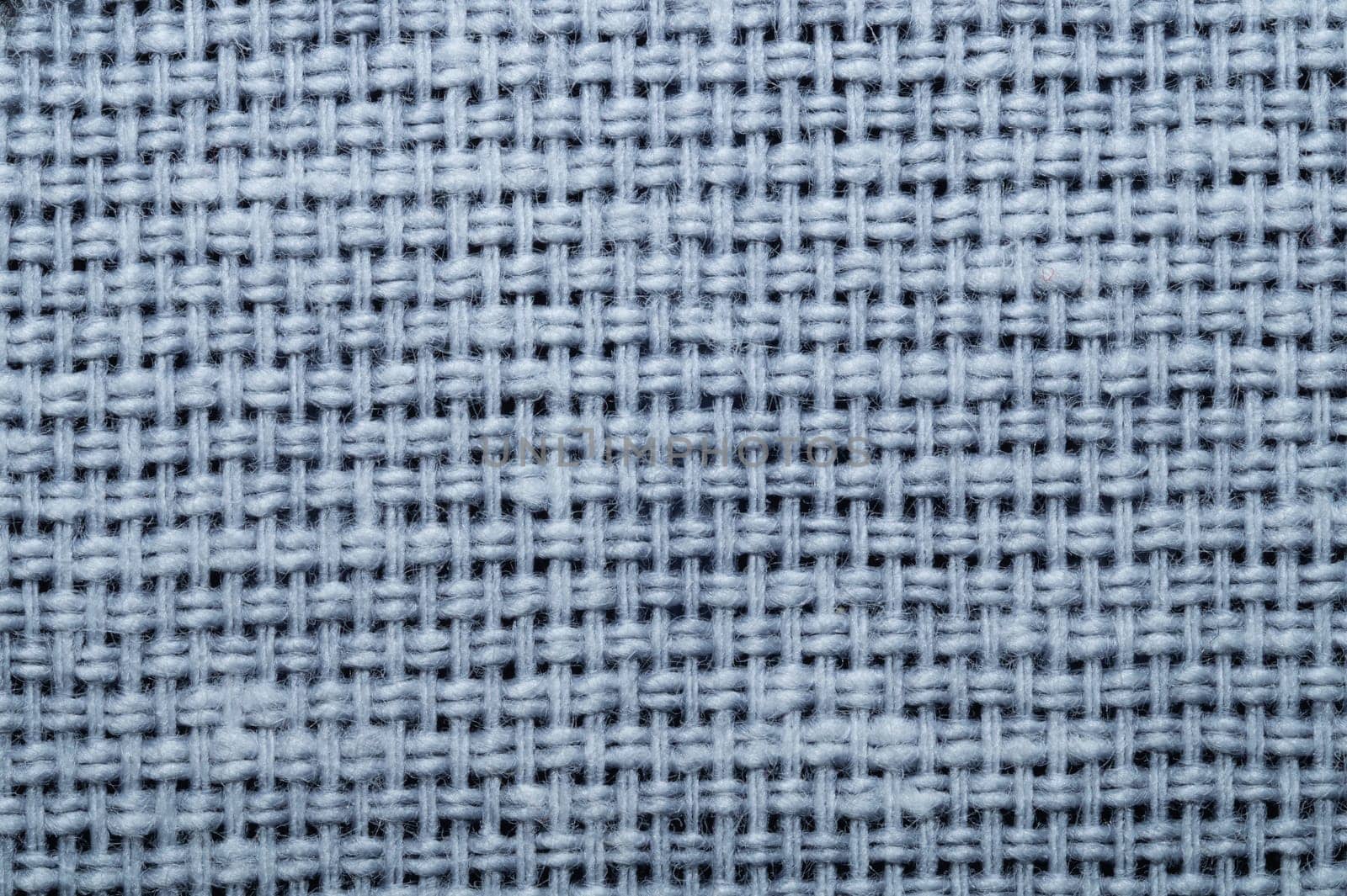 Fabric macro texture. knitted textile close up. woven background. woolen material