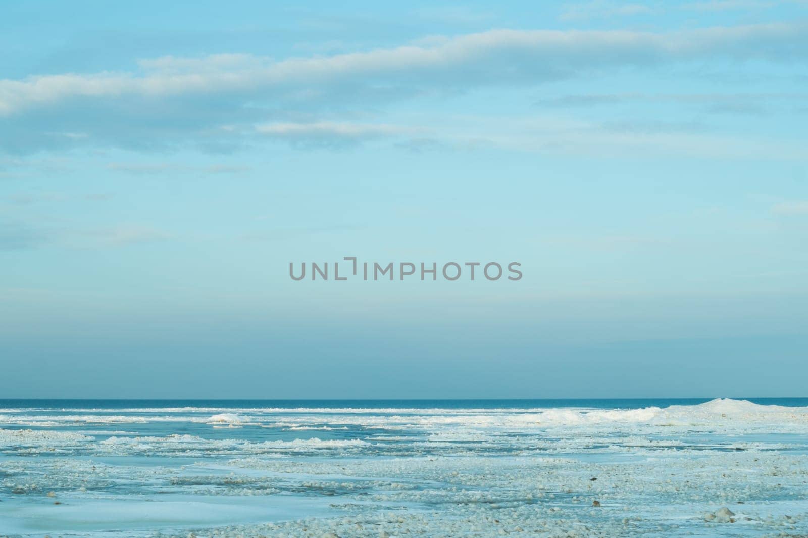 Blue frozen lake with the sky. winter landscape. nature background with a horizon line