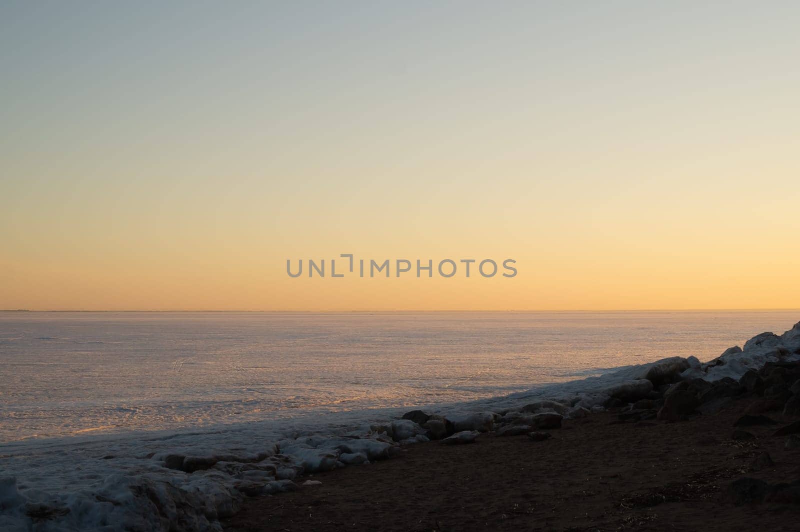 Frozen lake at sunset landscape background. horizon line