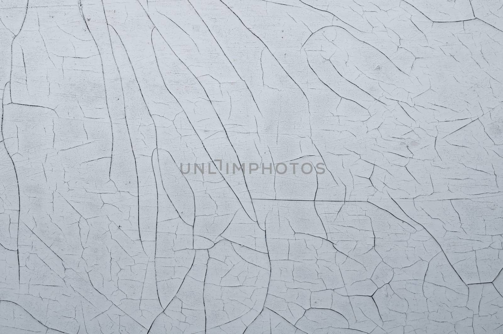 Cracked paint on a wooden surface. grunge texture with peeling paint on wood