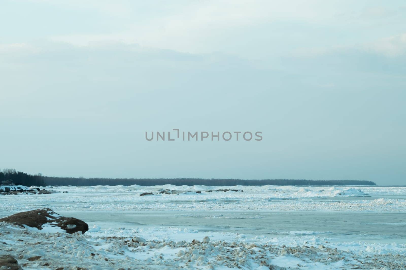 Blue frozen lake with the sky. winter landscape. nature background with a horizon line