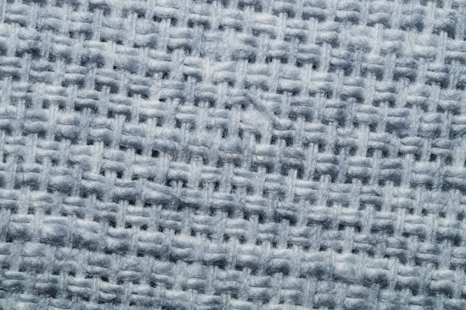 Fabric macro texture. knitted textile close up. woven background. woolen material