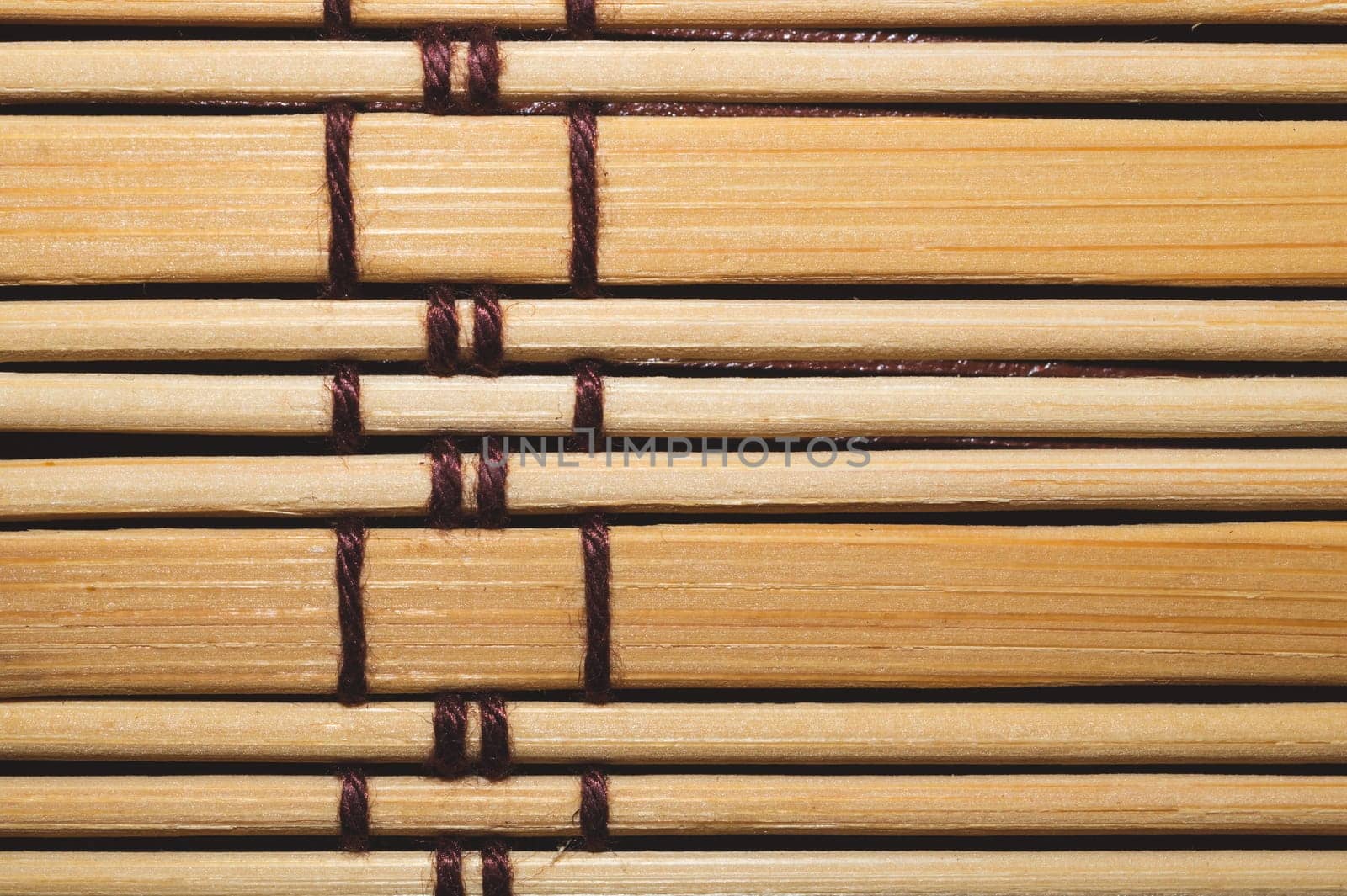 Bamboo mat background close up. wooden backdrop. wooden sticks bound together