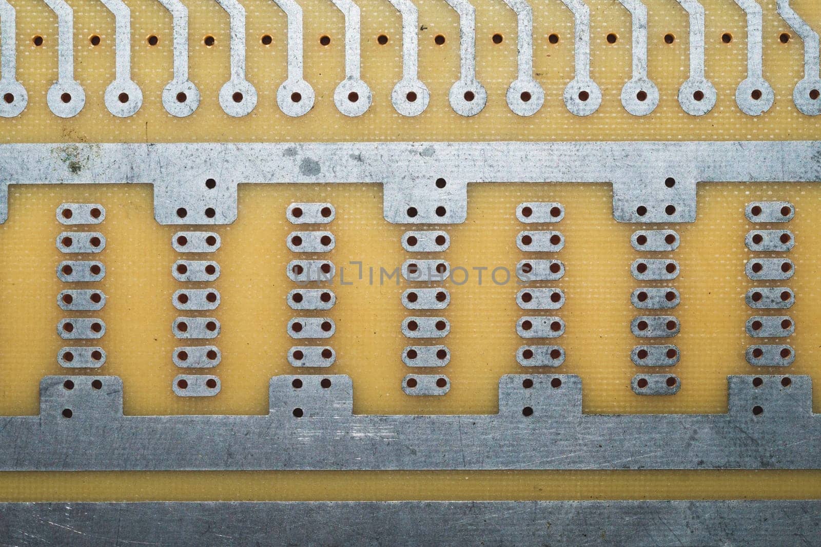 Printed circuit board without elements. textolite surface. template for soldering the circuit. perforated background