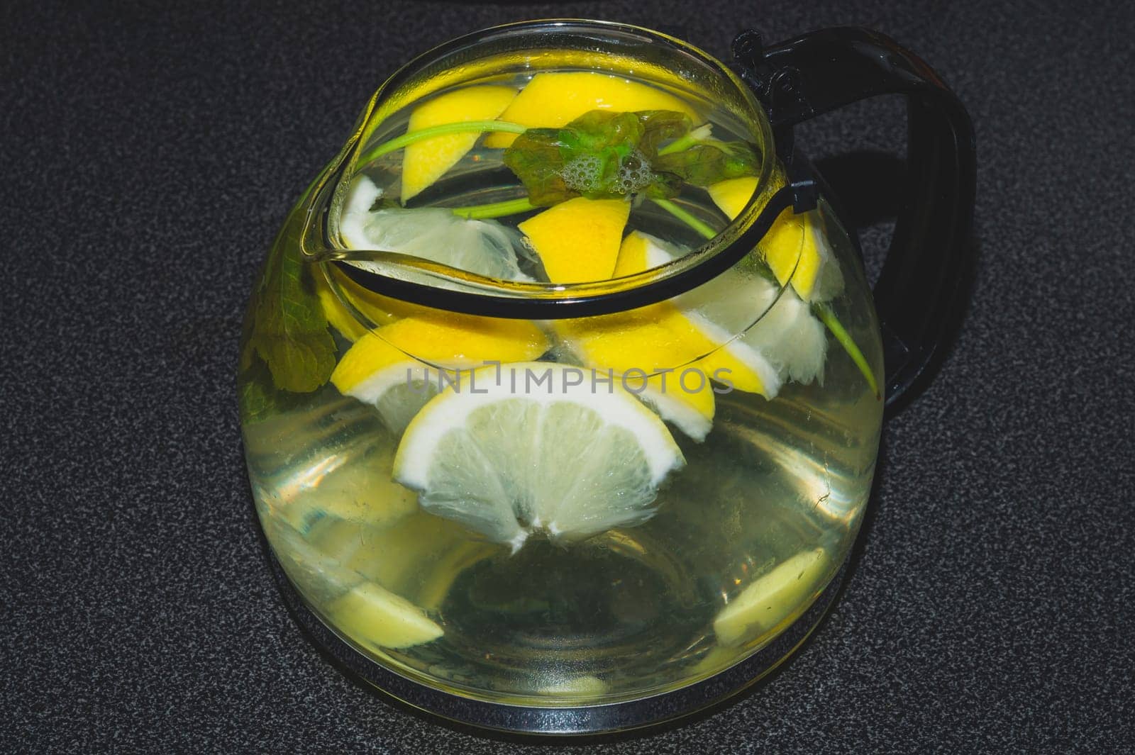Drink with lemon and mint. homemade lemonade. glass jug with refreshing beverage