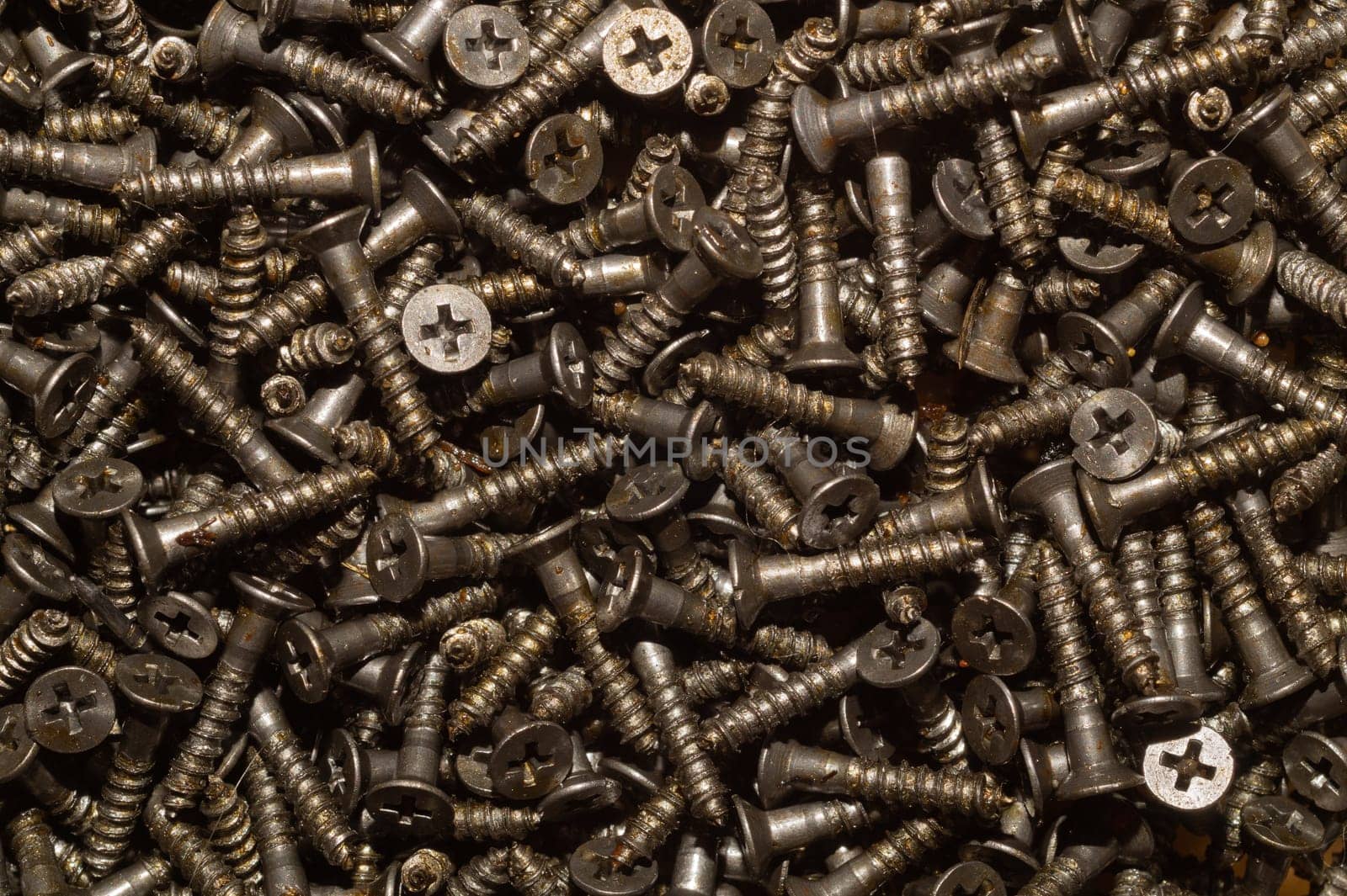 Screws background. heap of tapping screws. work tool. pile of fasteners
