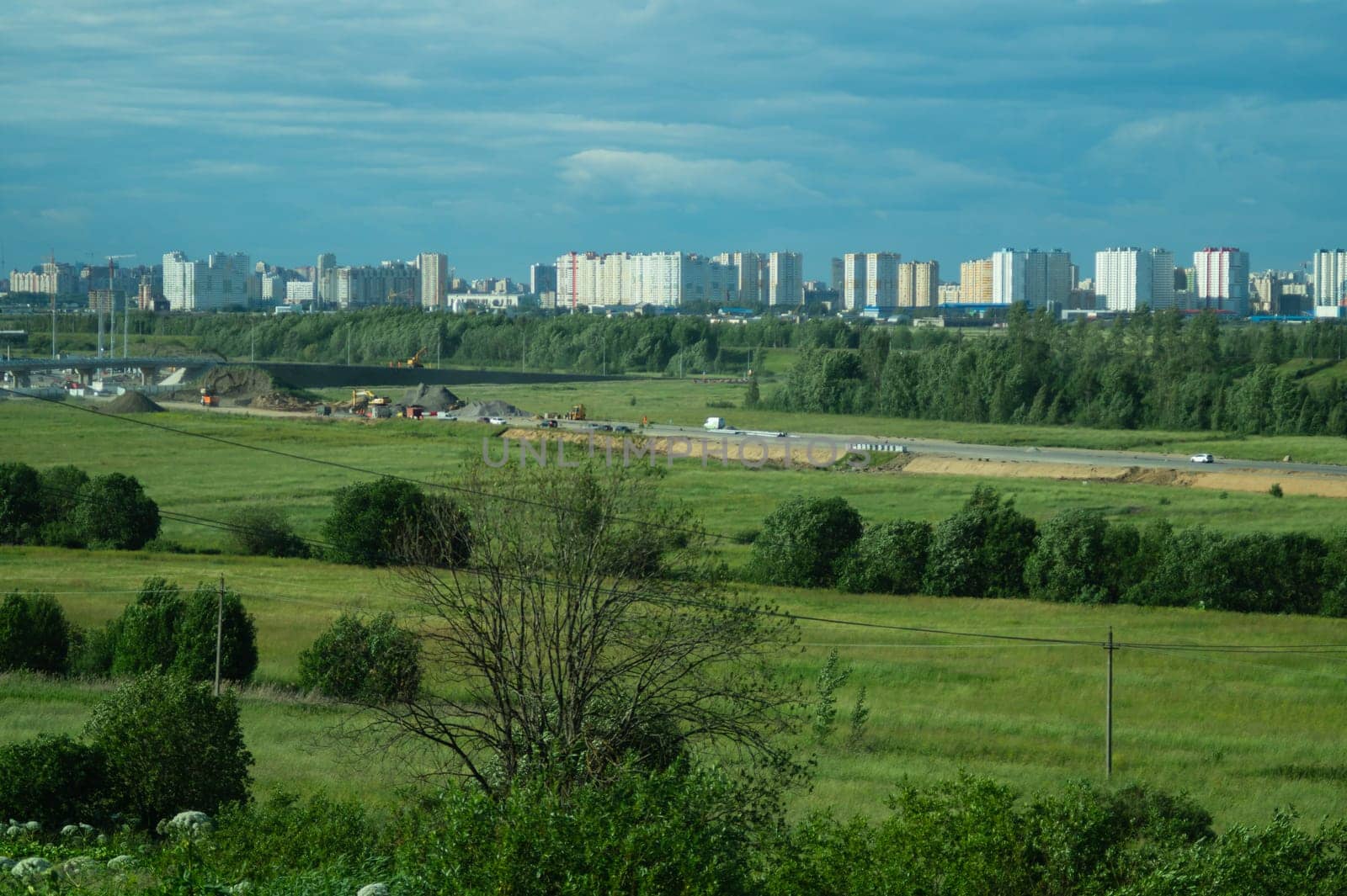 Urban cityscape panoramic view. horizon line with buildings. nature landscape with town and forest. blue sky. city into a distance