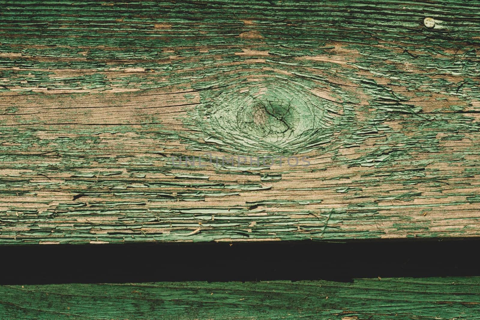 Abstract wood texture with peeling paint. green wooden backdrop. shabby painted wood background