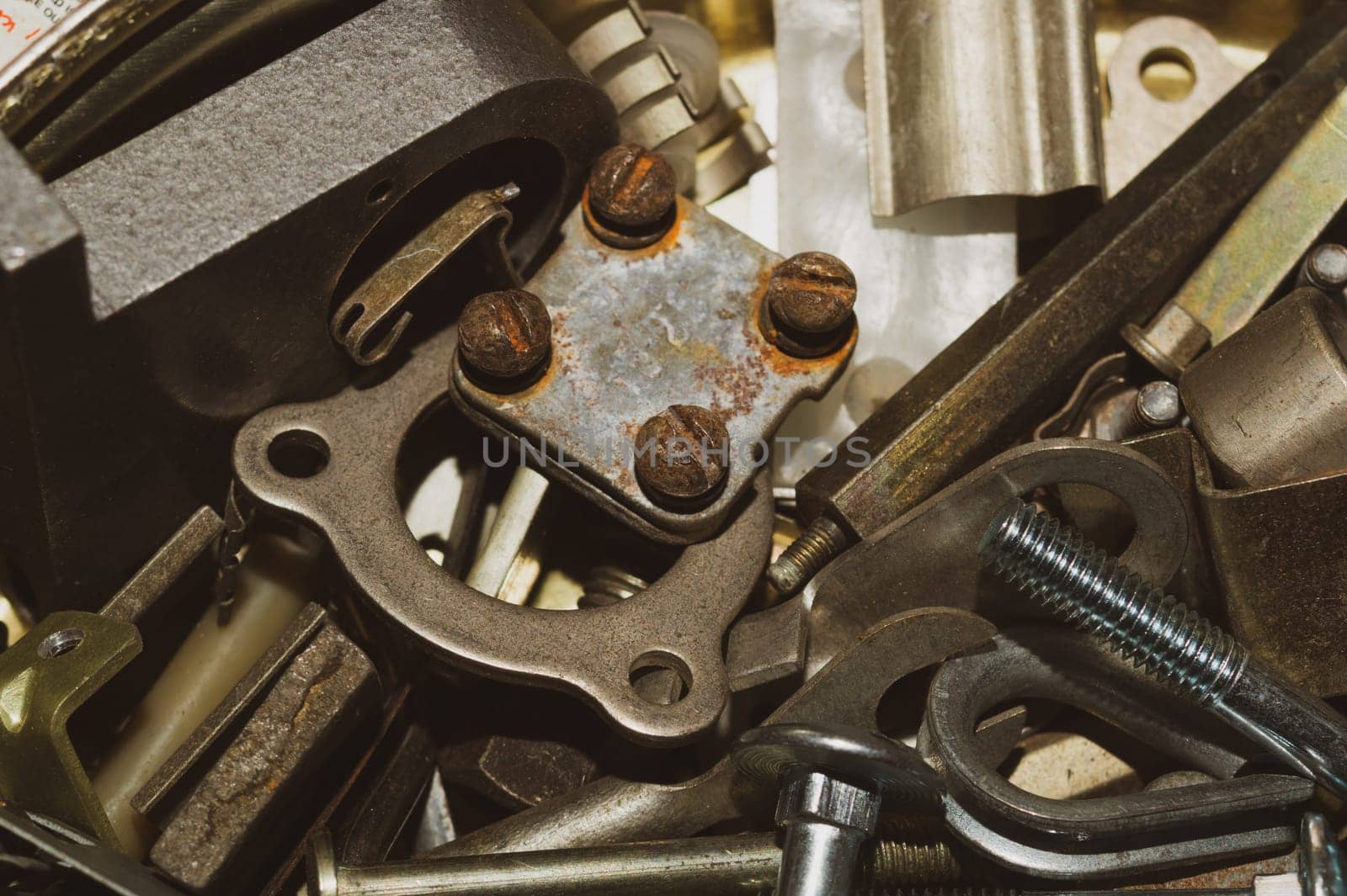 Pile of fasteners and screws close up. metal scrap. different metal details