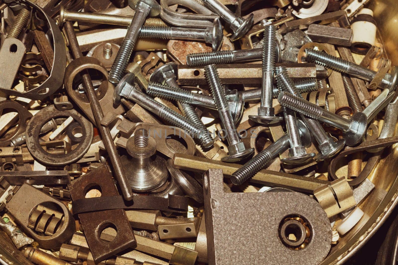Old screws background. heap of tapping screws. work tool. pile of fasteners. bolts and nuts. metal scrap