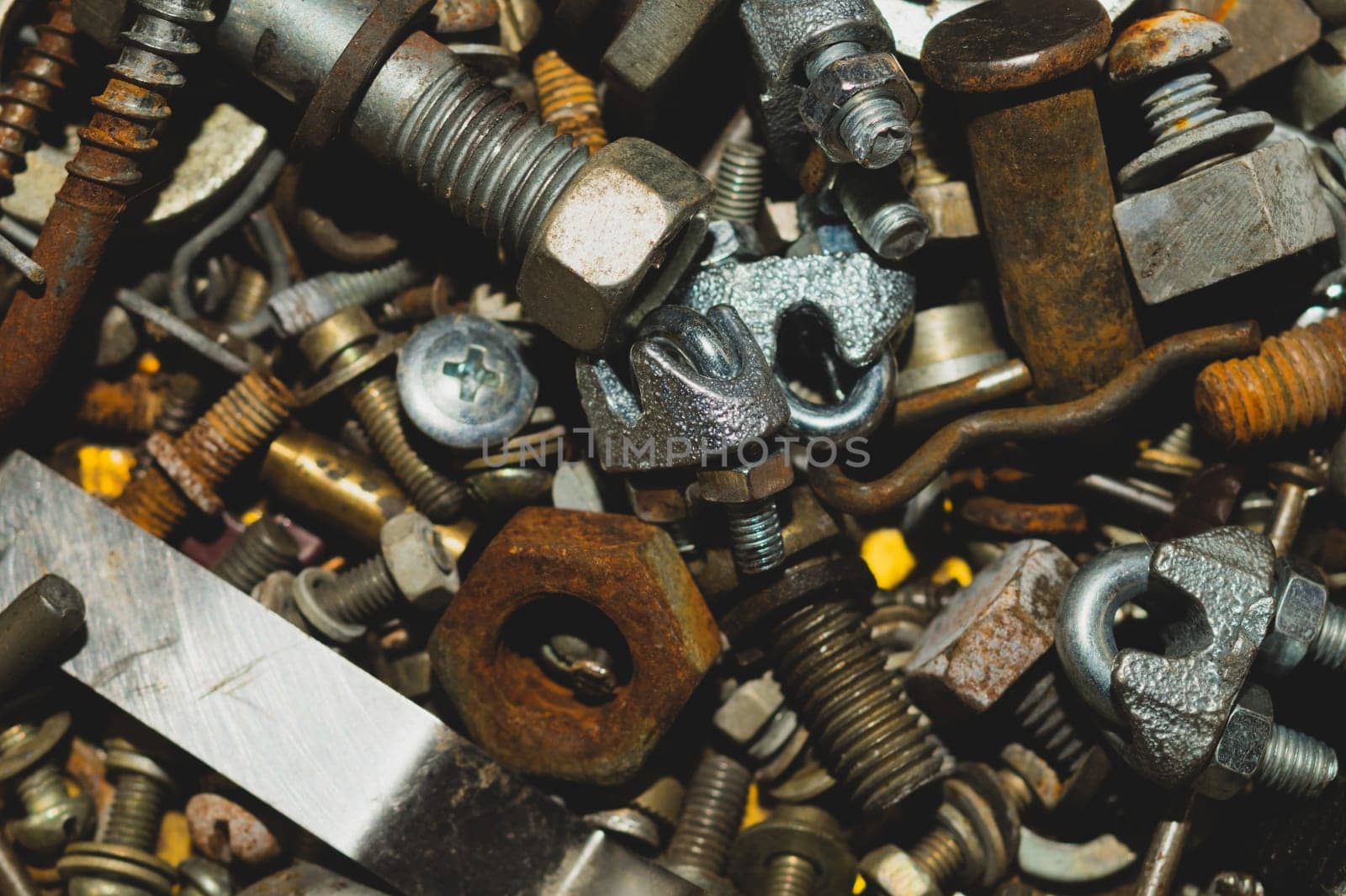 Old screws background. heap of tapping screws. work tool. pile of fasteners. bolts and nuts. metal scrap